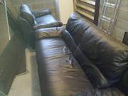 Black leather 2 and 3 seater sofas just under a year old